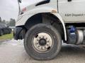 A close-up of the front tire and wheel of a 2018 International 26 Foot Cube truck featuring air brakes