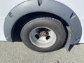 Close-up of a gray wheel arch with a steel wheel and a winter tire on a 2017 Chevrolet Express