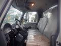 Interior view of a 2006 International 4300 truck showing a single seat with some wear and controls on the dashboard