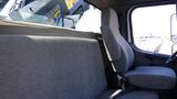 Interior view of a 2017 Freightliner M2 106 showing a gray fabric driver's seat and a side bench seat without any occupants