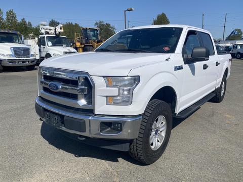 A white 2017 Ford F-150 pickup truck with a crew cab and chrome detailing parked in a lot