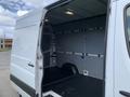 A 2017 Mercedes-Benz Sprinter with an open rear door revealing a spacious, empty cargo area with a smooth floor and metal walls