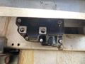 A black component mounted on a metal surface with several screws and connectors likely related to the mechanical system of a 2010 Ford F-550