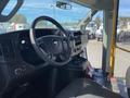 Interior view of a 2017 Chevrolet Express showing the steering wheel dashboard and front seats