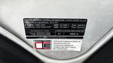 Close-up of a vehicle emission control label on a 2016 Nissan Frontier detailing regulations and specifications for the engine and fuel type