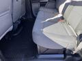 The image shows the rear bench seat of a 2019 Ford F-350 SD with gray fabric upholstery and a rubber floor mat