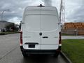 A 2021 Mercedes-Benz Sprinter van viewed from the rear showing a white exterior and the model name on the back door