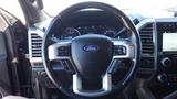 Steering wheel of a 2017 Ford F-350 SD featuring controls and the Ford logo in the center