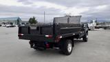 A 2008 Ford F-450 SD pickup truck with a flatbed and towing equipment parked in a lot