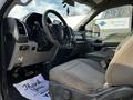 Interior view of a 2018 Ford F-550 featuring a steering wheel and driver seat with fabric upholstery and dashboard controls visible