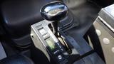 Close-up of the gear shift lever of a 2007 Sterling Acterra L7500 featuring a black knob and located on a dark console with gear indicators