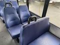 Interior seating of a 2018 Chevrolet Express featuring blue upholstered seats with a textured pattern and armrests