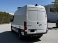 A white 2022 Mercedes-Benz Sprinter van viewed from the rear with a sleek design and cargo doors closed