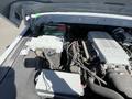 Close-up of the engine compartment of a 1962 Ford F-100 showcasing the battery and engine components with wiring and electrical systems visible