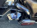 Close-up of a chrome engine cover and exhaust pipe of a 2004 Harley-Davidson Flhtcui motorcycle