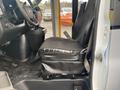 A black driver's seat in a 2017 Chevrolet Express showing visible wear and tear with a torn section on the seat cushion