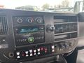 Dashboard of a 2017 Chevrolet Express featuring a radio, climate controls, and various buttons and knobs