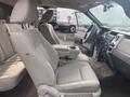 Interior view of a 2009 Ford F-150 showing front seats and dashboard with a steering wheel and center console