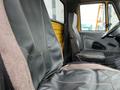 Interior view of a 2007 International 4300 truck showing two truck seats with black leather and cloth upholstery