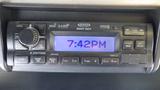 A car stereo display showing the time as 742PM with buttons for audio control and other settings