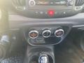 Interior dashboard controls of a 2015 Fiat 500L featuring climate control knobs and gear shift with console buttons