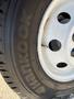 Close-up of a Hankook tire mounted on a wheel with visible lug nut holes and tread pattern