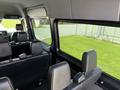 Interior view of a 2019 Mercedes-Benz Sprinter van showcasing multiple black leather seats and large side windows
