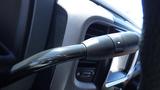 Close-up of the gear shift lever of a 2014 RAM 3500 showing the textured grip and control buttons