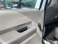 Close-up view of the interior door handle and window crank of a 2010 Ford F-550