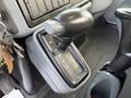 A gear shift lever in a 2007 International 4200 with a black handle and a control panel showing R N 2 1 markings