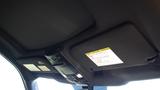 View of the interior ceiling panel of a 2017 Ford F-350 SD featuring overhead controls and overhead storage compartments