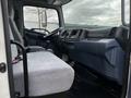 Interior view of a 2006 Hino 268 showing the driver's seat and passenger seat with a dashboard and steering wheel in a gray fabric upholstery