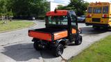 A 2018 Kubota RTV X1100C utility vehicle with an orange and black exterior and a flatbed in the rear