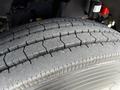 Close-up of a treaded tire from a 2014 Kenworth T370 showcasing deep grooves and textured surface designed for traction and durability