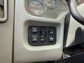 Control panel of a 2009 International 7500 featuring buttons for mirror adjustment light panel and dashboard panel settings
