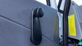 A close-up of a black hand crank used to adjust the window on the door of a 2019 International 4300 truck