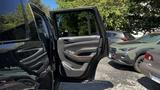 A 2018 Chevrolet Tahoe with its driver-side door open showcasing the interior door panel and handle