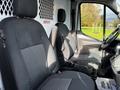 Interior of a 2020 Ford Transit showing two front seats with fabric upholstery and a central console between them