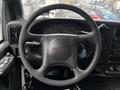 Steering wheel and dashboard of a 2005 GMC C5 Duramax featuring gauges and control buttons