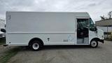 A 2006 Ford Econoline cargo van in white with a boxy shape and a side entrance door