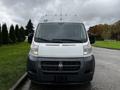 Front view of a white 2016 RAM Promaster showing the grille headlights and large windshield with no visible damage