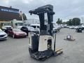 A 2004 Crown RR5210-35 electric pallet jack with a vertical mast and fork extensions positioned for lifting or moving pallets