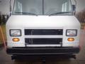 Front view of a white 2003 Freightliner MT45 chassis featuring headlights and a black grille