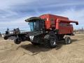 A red 1997 Massey Ferguson 8680 combine harvester with a large front header and four wheels positioned on an unpaved ground