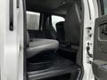 Interior view of a 2005 GMC C5 Duramax showing the driver's side rear seat and floor area with gray upholstery