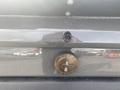 A 1966 Ford Mustang emblem on the rear of the vehicle featuring the Ford logo and a galloping horse design