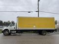 A 2018 International 26-foot cube truck with air brakes featuring a bright yellow box and a white cargo area with a logo on the side