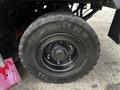 A close-up of a black tire from a 2007 Tennant Sentinel featuring a sturdy tread pattern and a central hub with visible bolts and a Continental logo