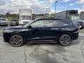 A black 2023 Acura MDX with red brake calipers and sporty rims is parked, showcasing its sleek design and modern features