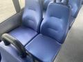 A pair of blue upholstered seats from a 2017 Chevrolet Express shuttle van